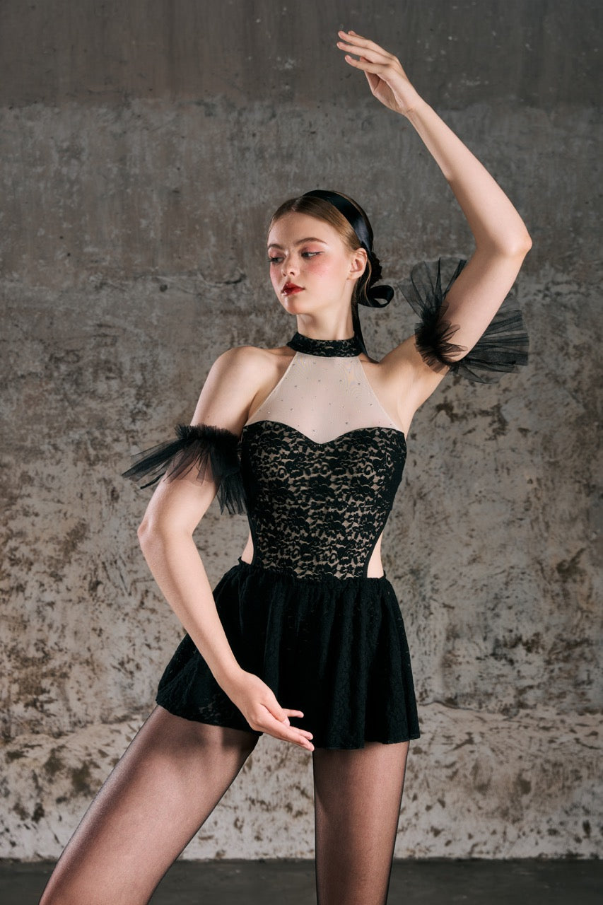 Dancer in a black lace outfit with a textured wall background design by Spincess Aerial Pole Dance Wear Ballet Barre