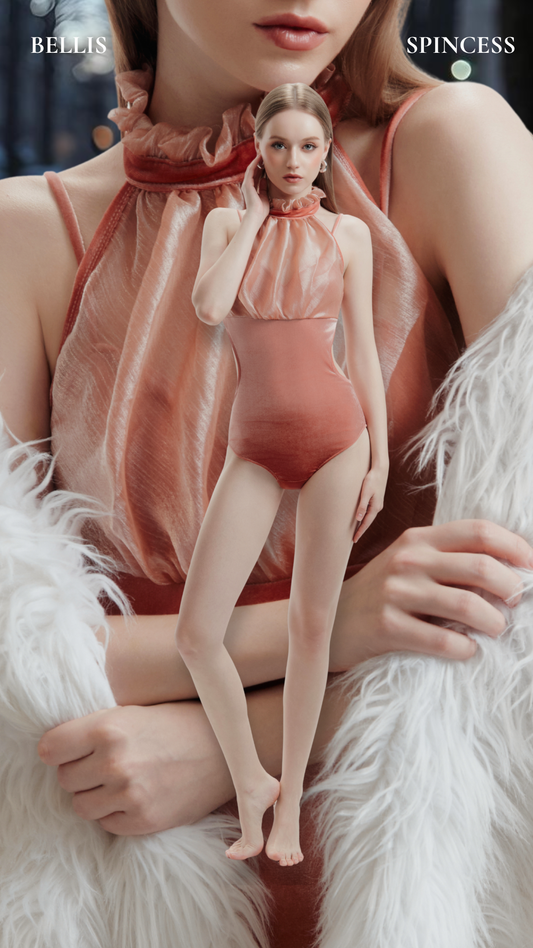 Woman in a pink outfit sitting on a white fur surface with a doll-like figure next to her. Bellis Leotard Bodysuit Design by Spincess Pink Peach Model